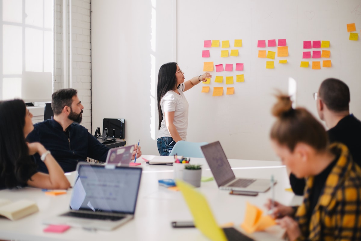 Creative team reviewing grid of AI-generated product images for batch quality control