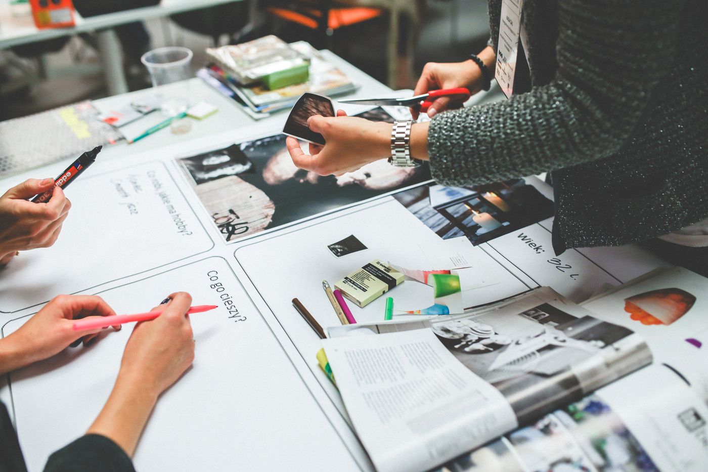 Team reviewing creative options at desk — curator decision gate