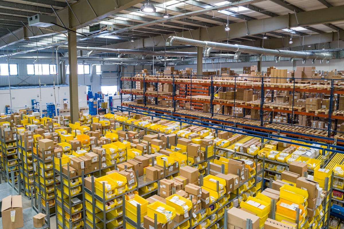 Warehouse shelf with many product SKUs organized for batch ecommerce photography workflow